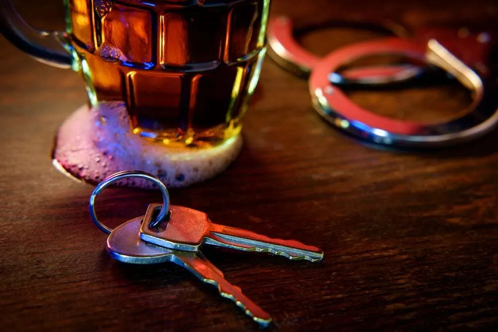 A Beer Glass And A Set Of Keys On A Table